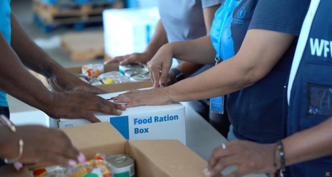 Humanitarians prepare food ration kits after a hurricane made landfall in Jamaica.