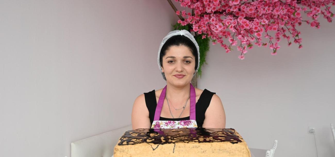 Lika dans son café à Ozurgeti, fière de ses gâteaux fraîchement préparés, symbole de son nouveau départ et de sa détermination à offrir une vie meilleure à ses enfants.