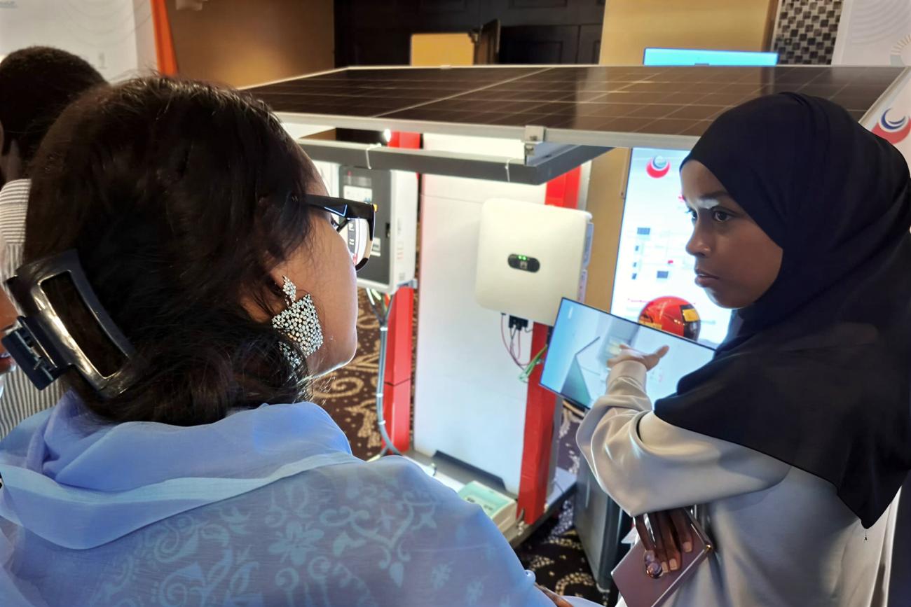 A young Djiboutian solar energy entrepreneur presents her company’s products to a participants during a national forum.