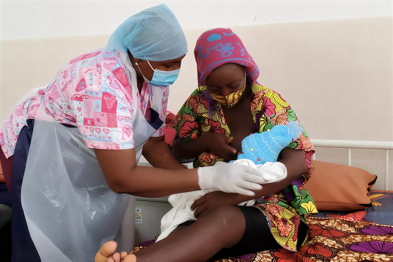 A nurse in Sierra Leone tends to a mother and her baby.