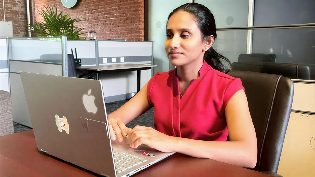 A woman in Sri Lanka uses her laptop.