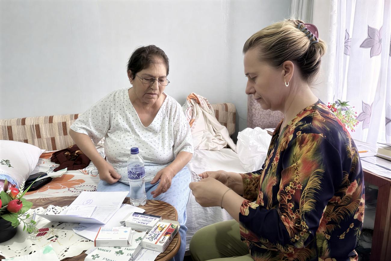 A woman in Albania takes care of an elderly woman.