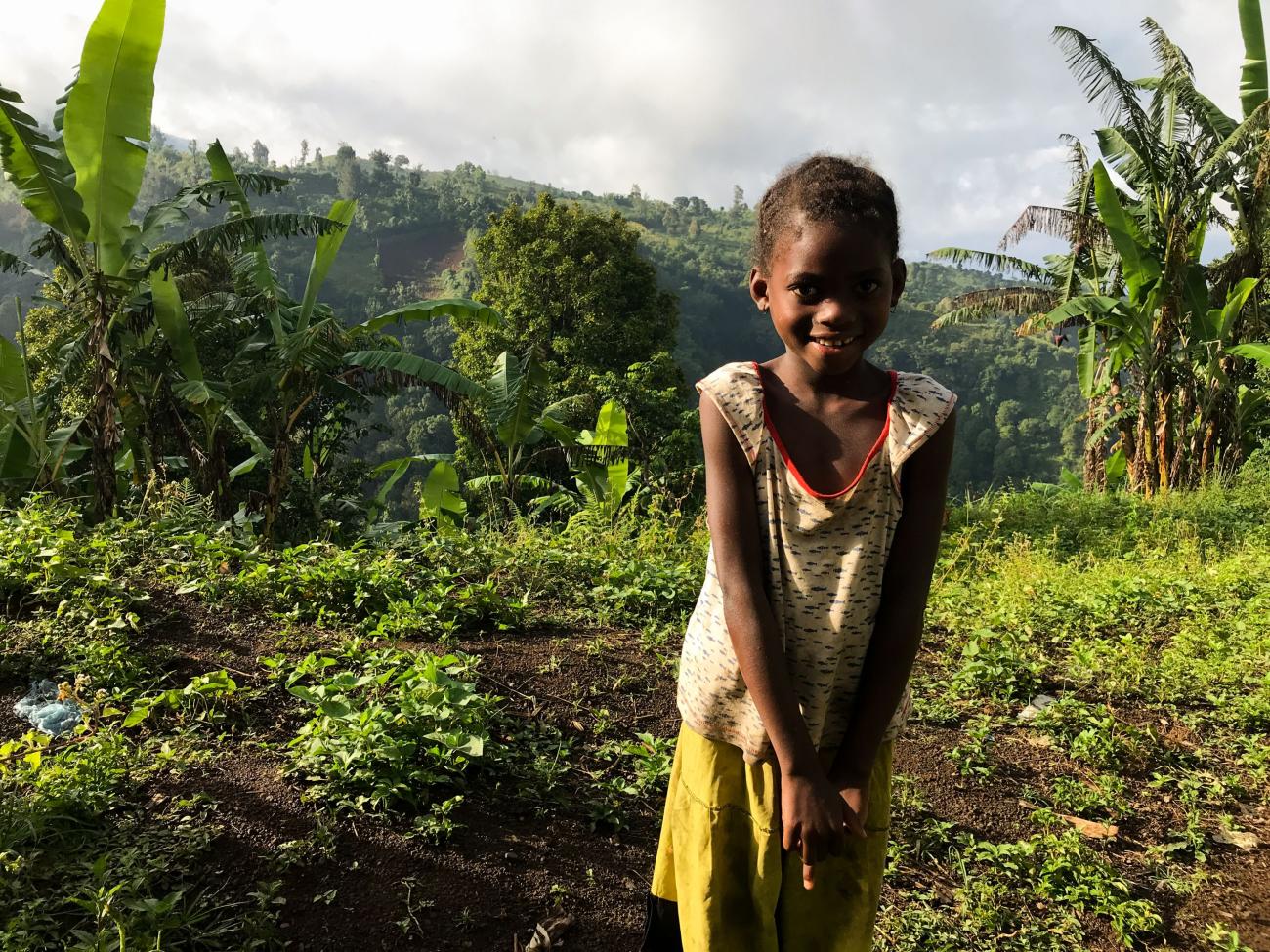 A young girl in a field in Comoros.