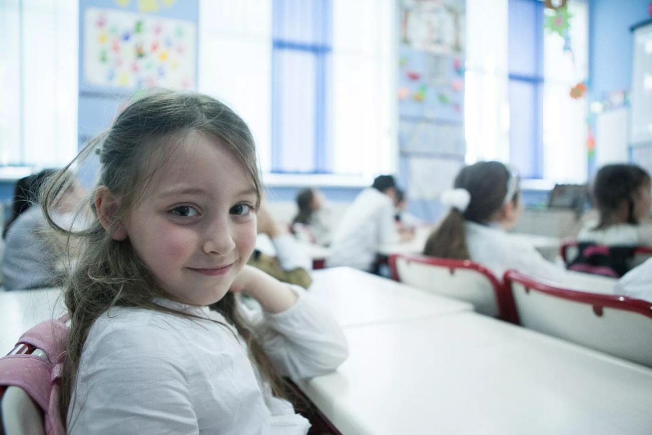 A young girl in Georgia sits in a classroom.