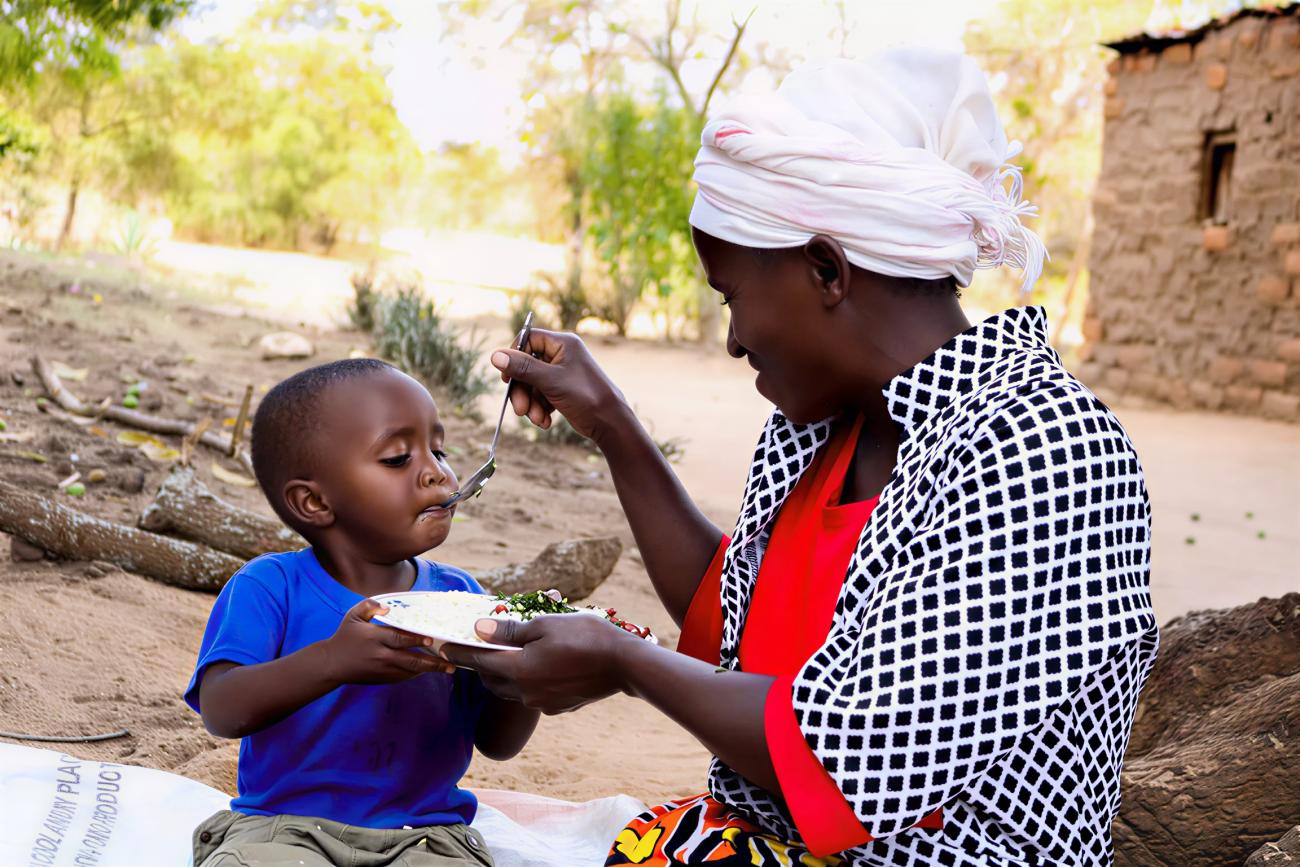 A mother in Kenya feeds her son.
