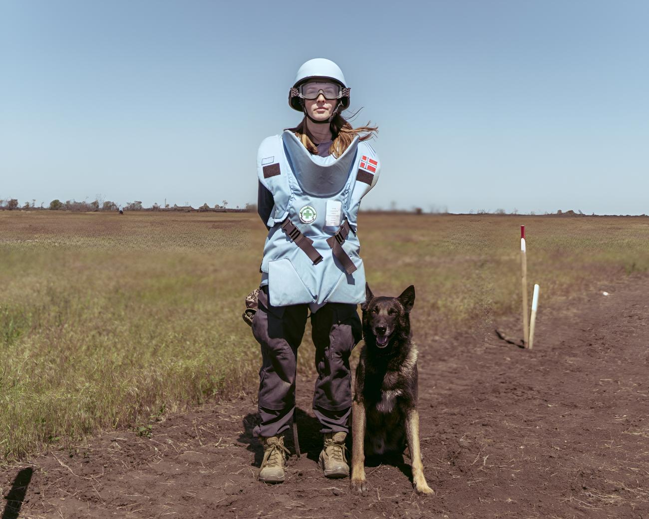 A mine detection dog handler, with her dog.