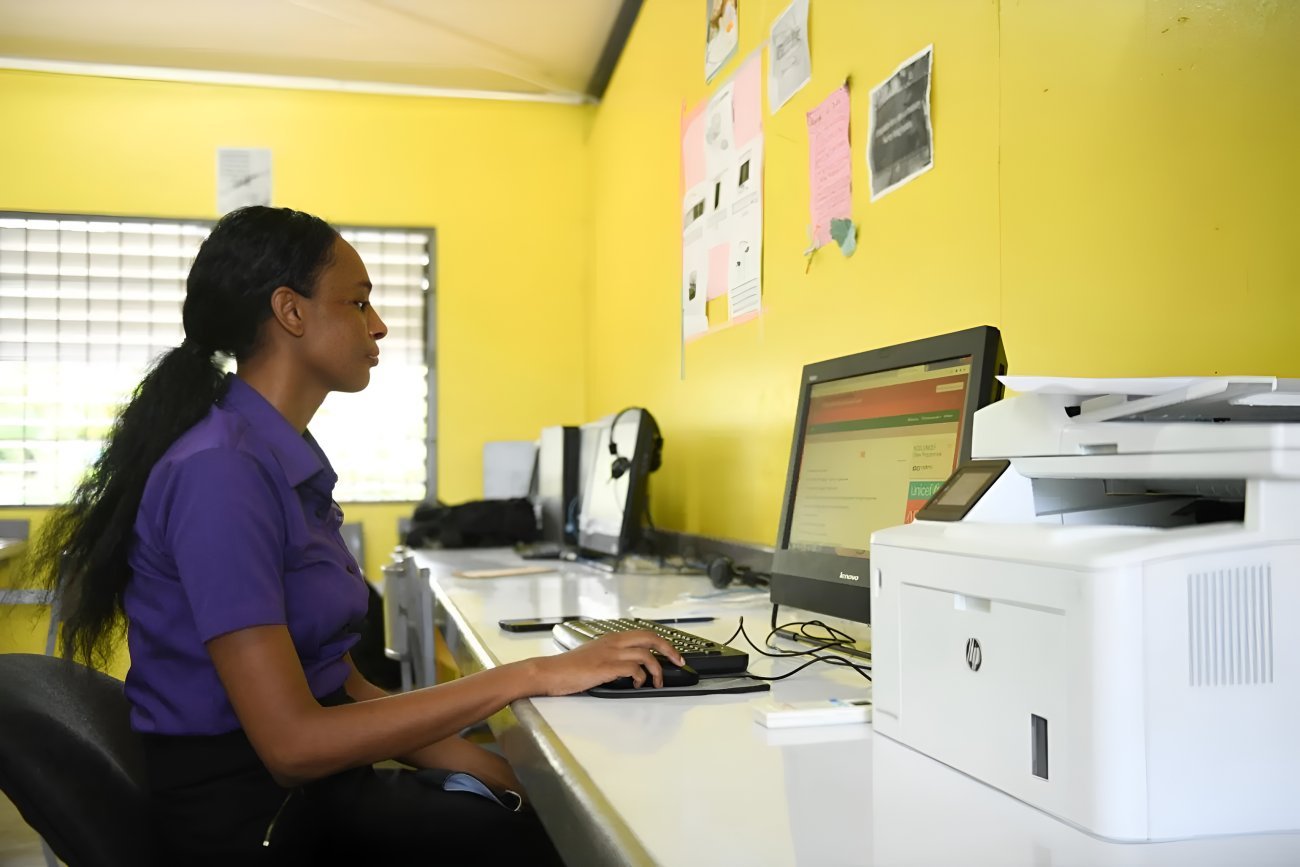 A young woman in Jamaica uses a computer.