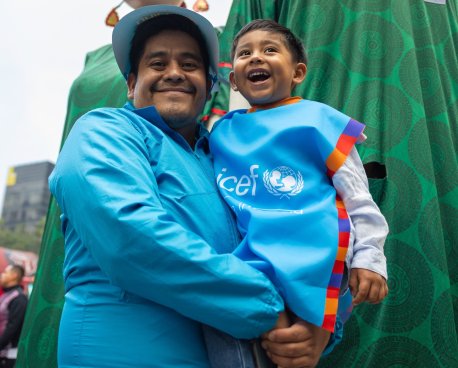 A man in Mexico holds his son.