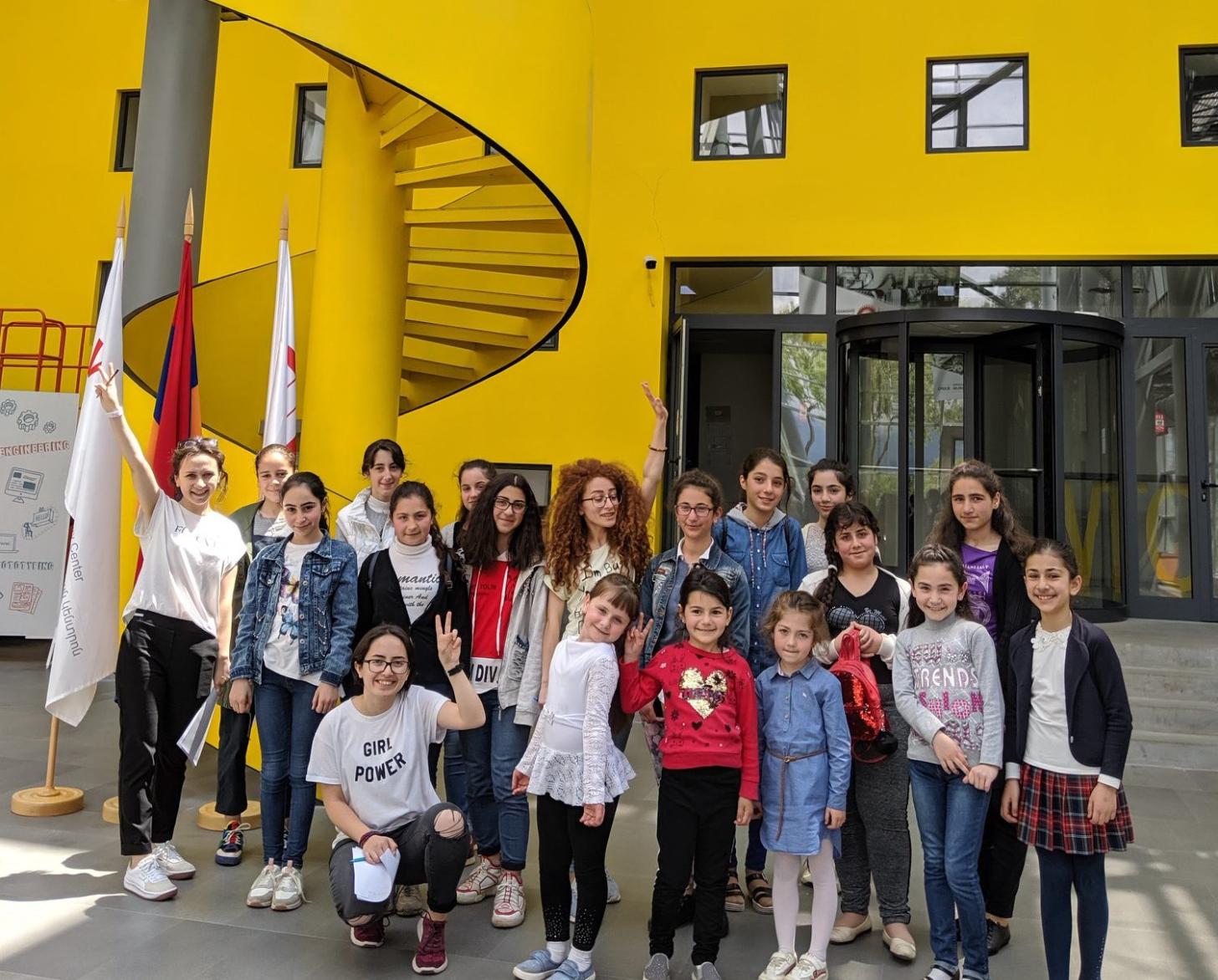 Girls stand outside the buidling