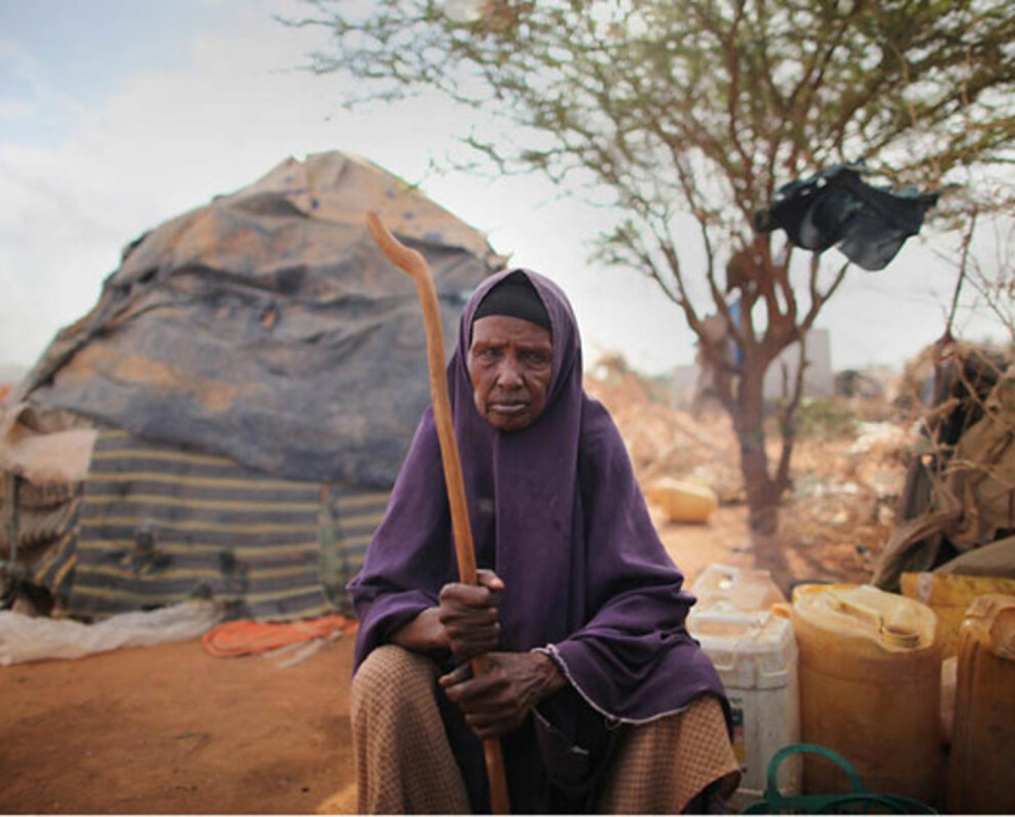 Older resident living in the Internally Displaced People camp sits outside a tent.