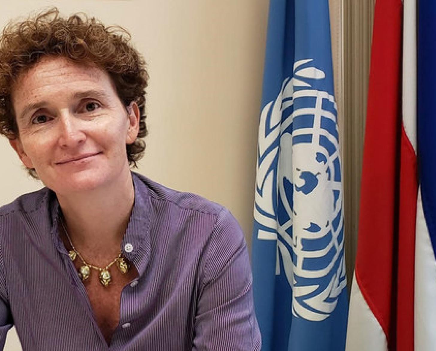 Photo of Alice Shackelford in front of the UN and Costa Rican flags.