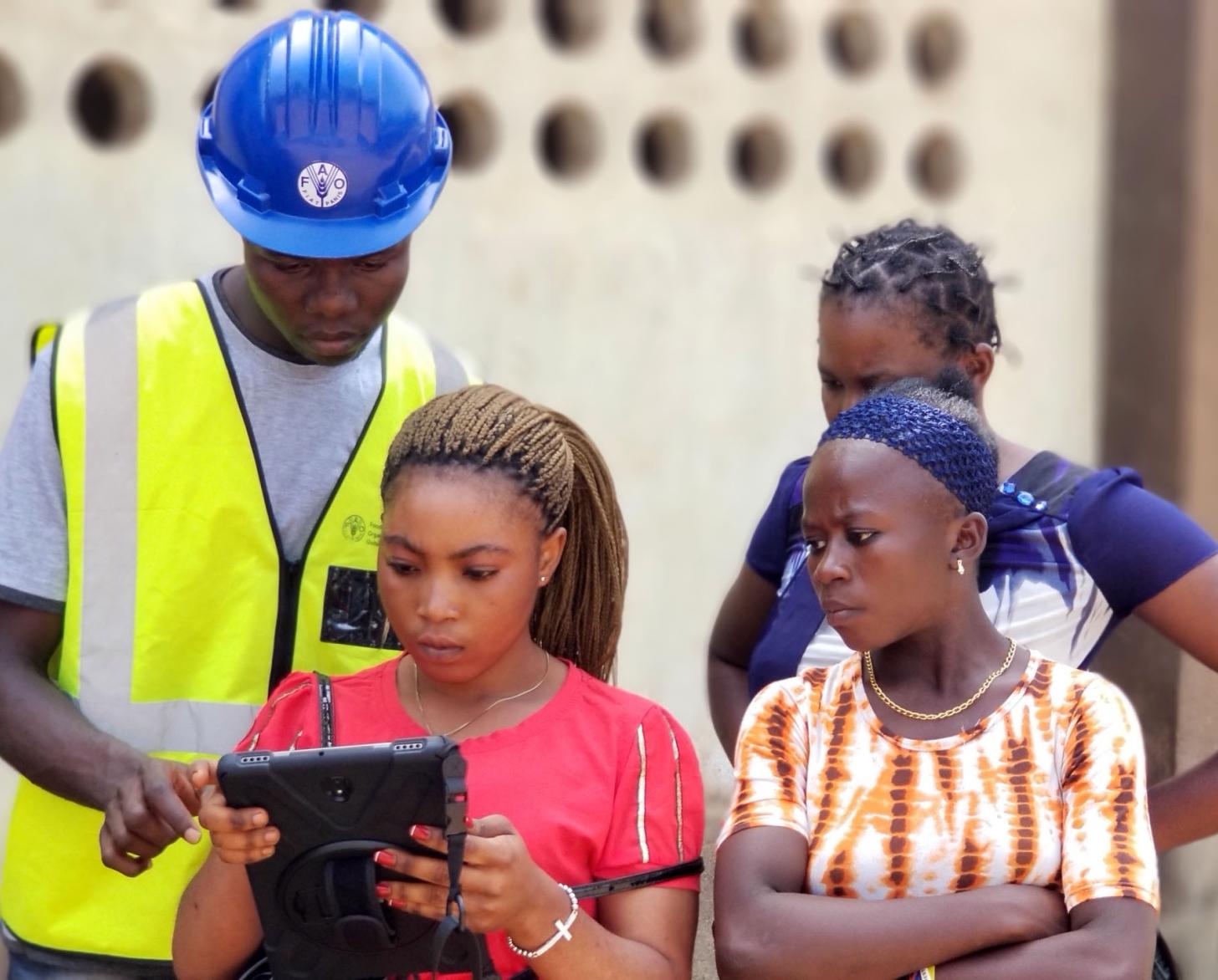 Young women are trained as para-surveyors to map family and village land boundaries. (Please note image was taken prior to COVID-19 social distancing measures were in place.