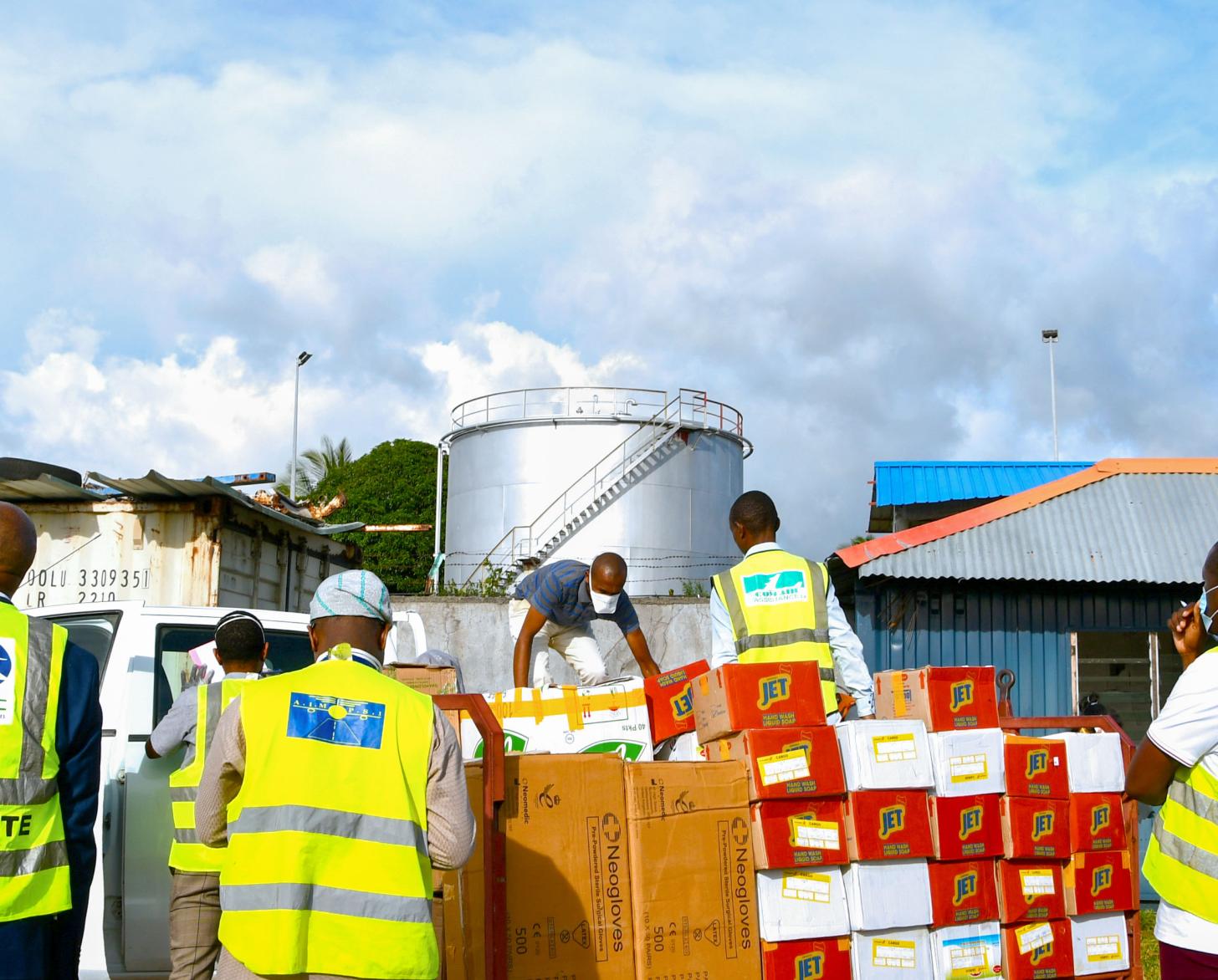 Local government staff receive several donated boxes containing personal protective equipment.