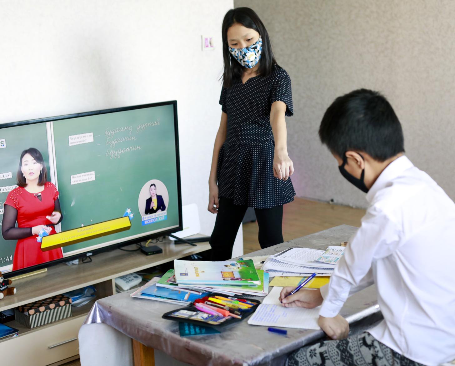 Siblings are attending tele-classes at home in Mongolia