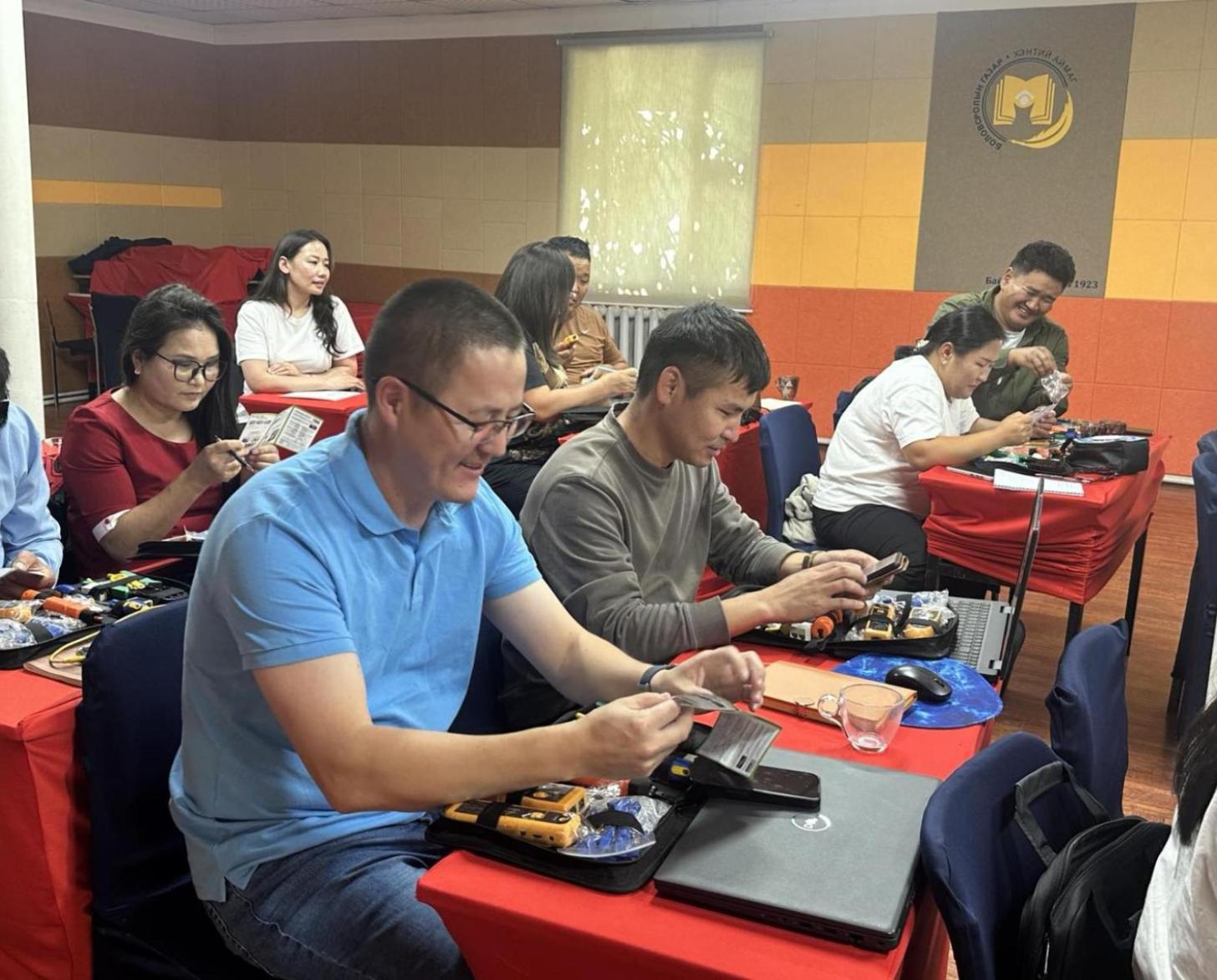Teachers receiving hands-on training on using network cable in Khentii province