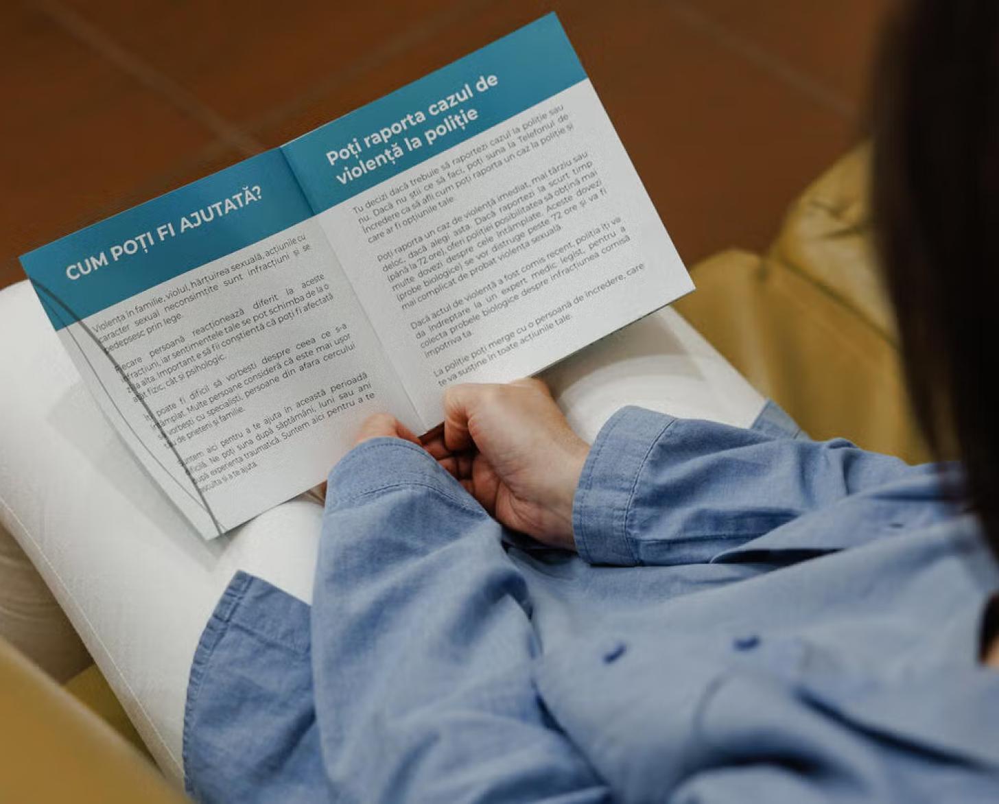 A Moldovan woman reads a pamphlet about gender-based violence.