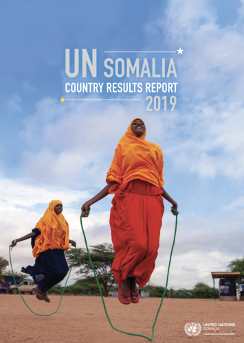 Two young girls happily jump rope under a beautifully bright blue sky.