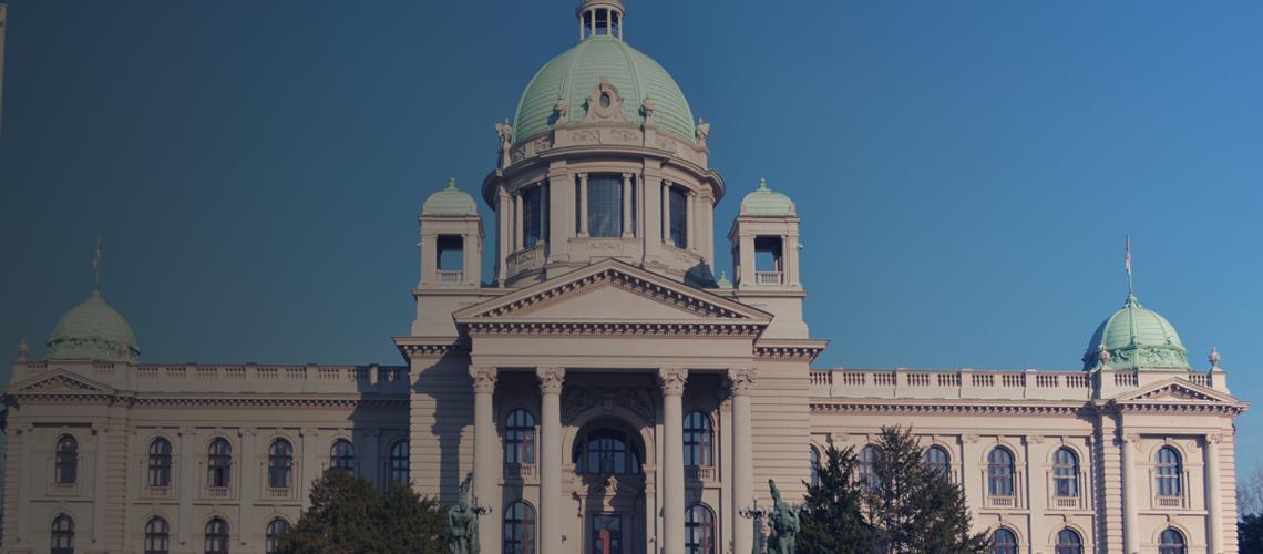 A wide shot of a building in Serbia against a bright blue sky.