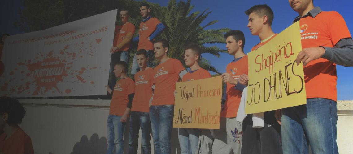 Photo shows young people holding signs during a march during 16 Days of Activism.