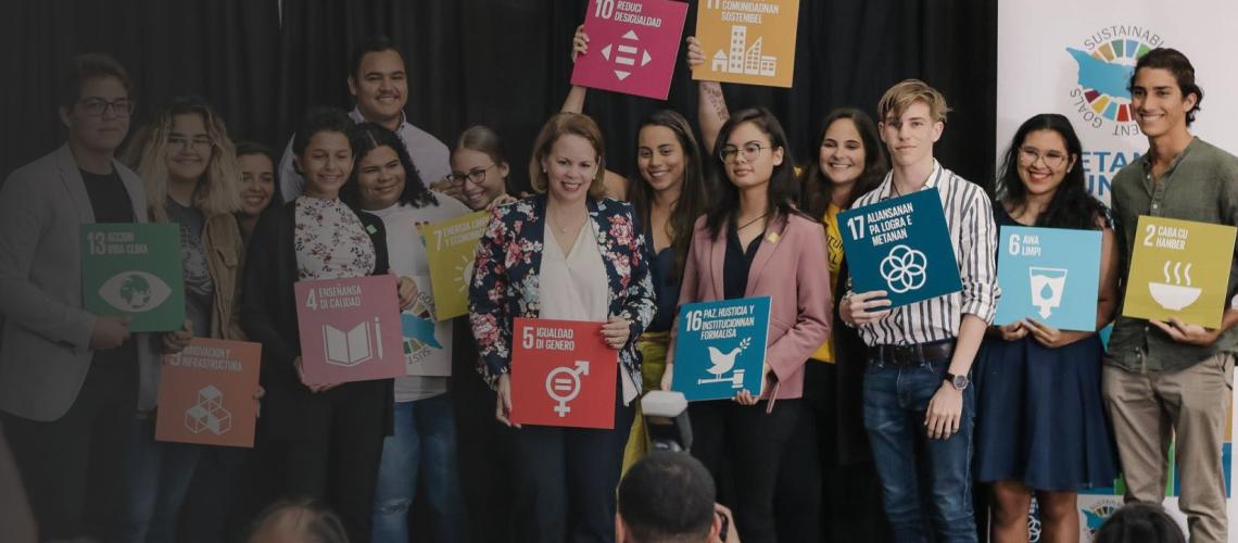 Participants from the SDG Aruba Commission Young Voices Youth Programme holding the SDGs signs.