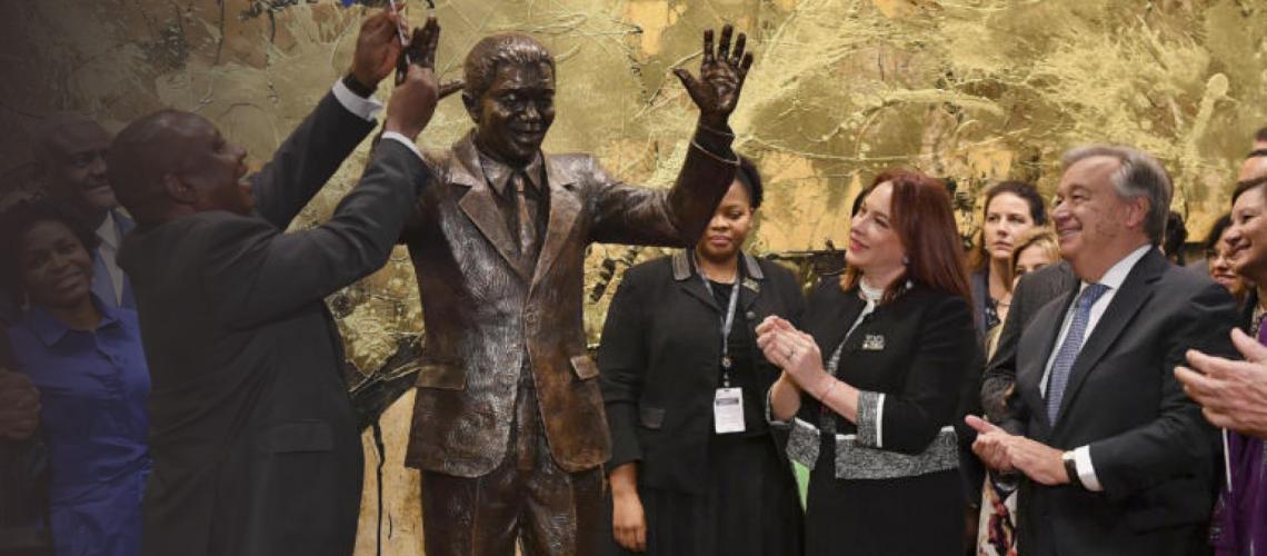 The Secretary-General and other UN officials celebrate as they unveil a statue of Nelson Mandela's at UN Headquarters in New York.
