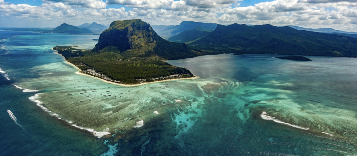 An areal view of the ocean and an island. 