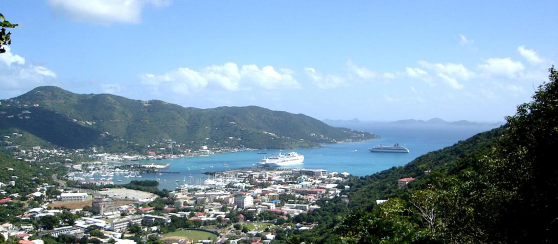 A landscape image of a town by the ocean on a beautiful day. 
