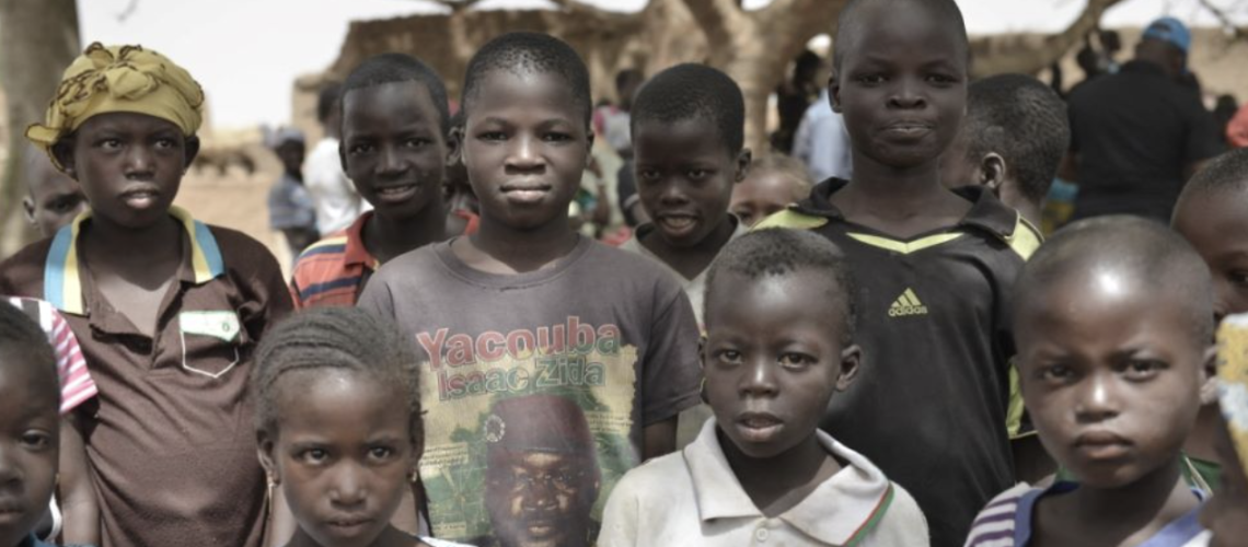 An image of several serious children looking directly at the camera. 