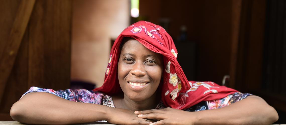 Woman in Comoros in a red headscarf smiling at the camera